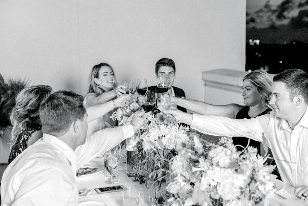 Bride and groom sharing a wine cheers with their immediate friends at their micro wedding at Hotel Bennett rooftop