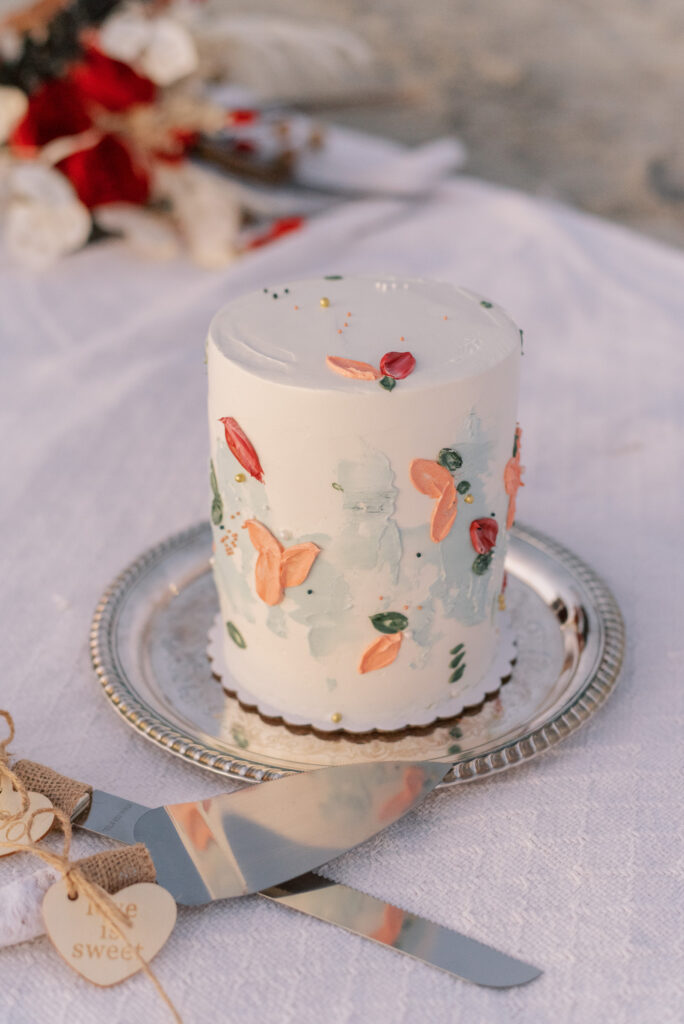 Watercolor painted mini cake for beach elopement 