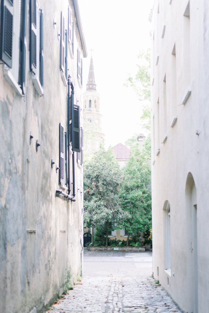 Cobblestone alley in historic downtown Charleston SC behind St Phillips Church.