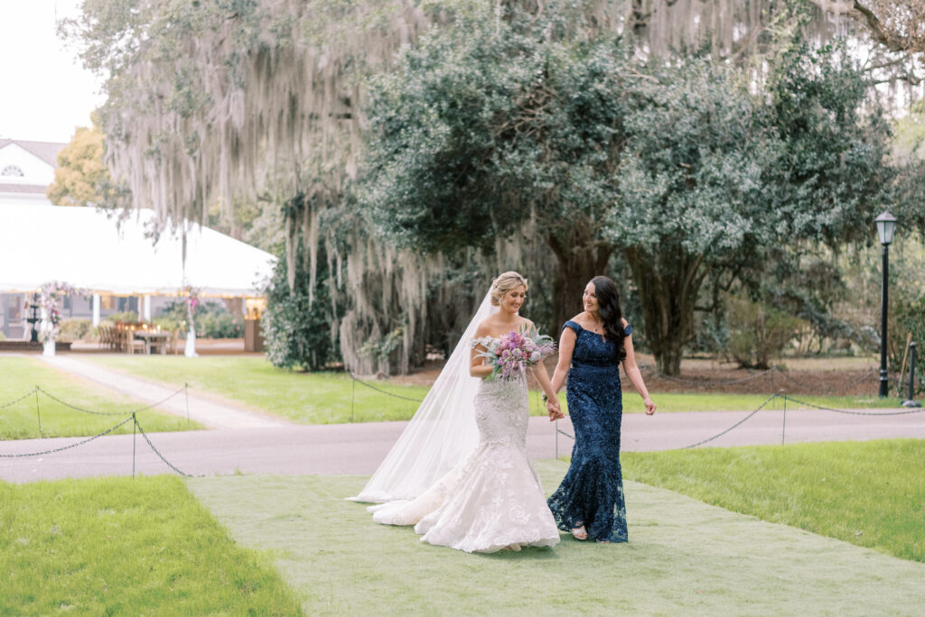 A mother walks her daughter down the aisle at Legare Waring House in Charleston