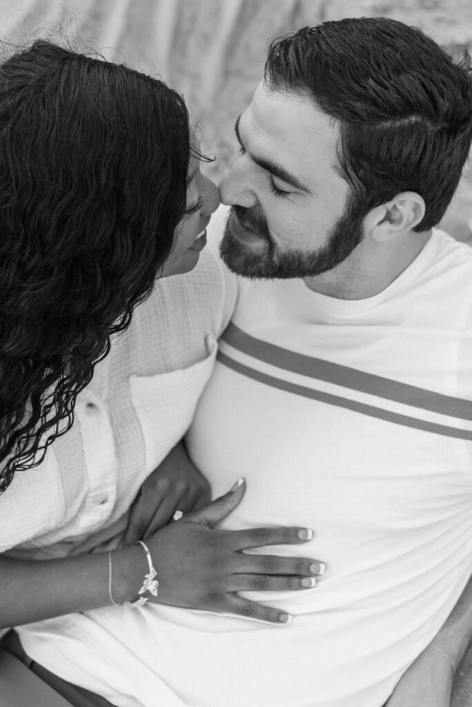 black and white close up of a couple smiling nose to nose