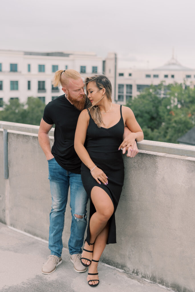 couple standing romantically together on a parking garage overlooking charleston