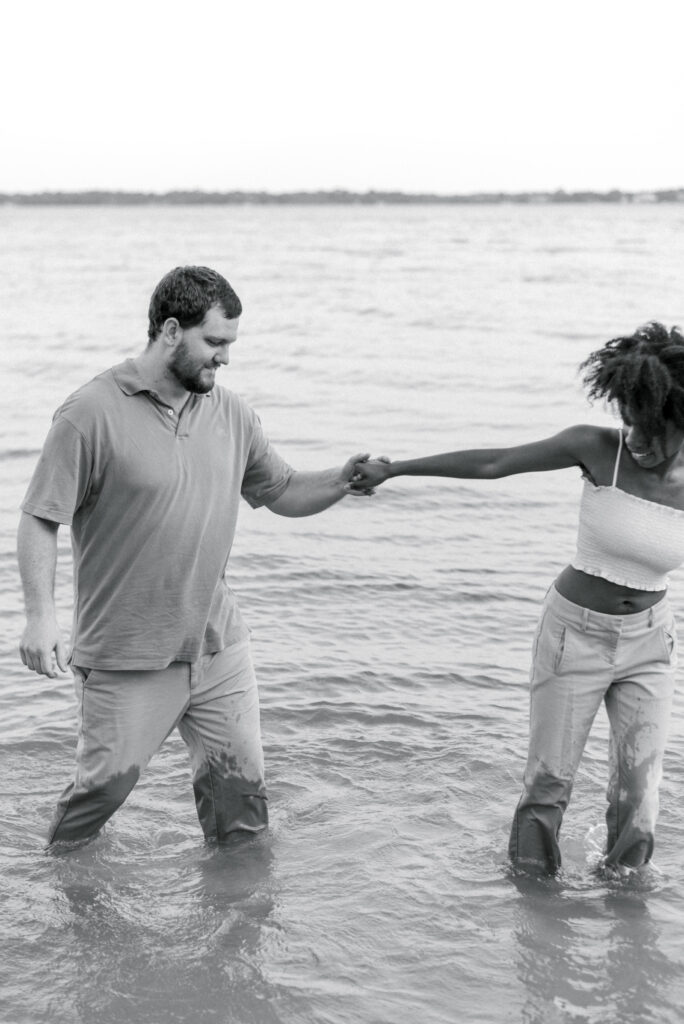 black and white portrait of couple knee deep in the water