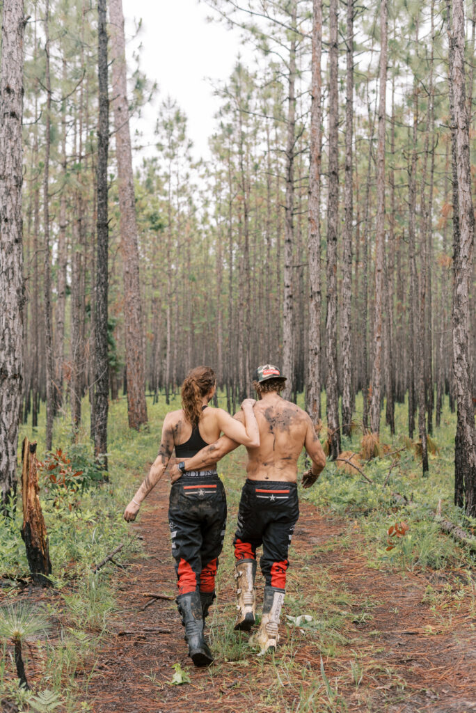 Couple lean on each other and walk away into the woods