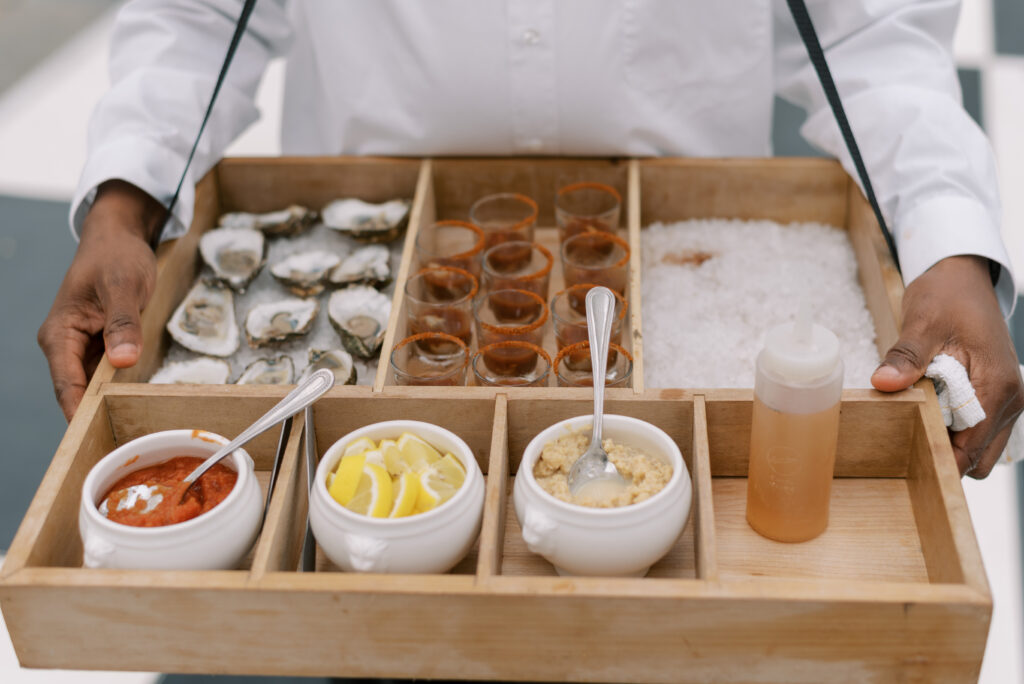 A server holds an oyster tray