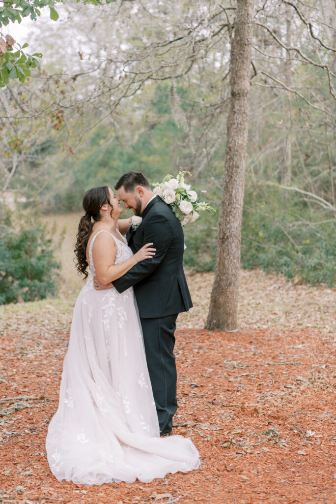 Bride and groom hug and laugh together on their wedding day